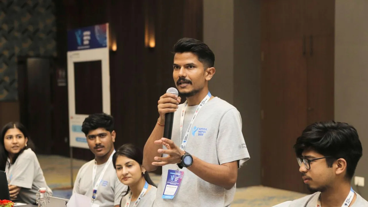 Ravindra Yadav speaking with a microphone at APIGA Nepal 2026